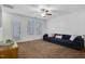Bright living room with large windows and a cozy, comfortable blue sofa at 3924 Volkswalk Pl, Raleigh, NC 27610