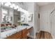 Well-lit bathroom featuring a double vanity with granite countertops and a glass-enclosed shower stall at 4014 Peeler Ct, Rolesville, NC 27571