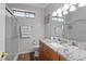 Modern bathroom featuring granite countertops, white cabinets and a glass shower with gray accents at 4014 Peeler Ct, Rolesville, NC 27571
