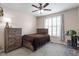 Cozy bedroom with wooden furniture set, white framed windows and neutral walls, carpeted floor at 4014 Peeler Ct, Rolesville, NC 27571