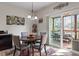 Cozy dining area featuring a round table, stylish lighting, and access to outdoor deck at 4014 Peeler Ct, Rolesville, NC 27571