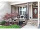 Inviting front porch with stone accents, comfortable seating, and attractive landscaping at 4014 Peeler Ct, Rolesville, NC 27571