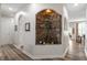 Elegant hallway showcasing a stone-accented alcove with plants and leading to various rooms of the house at 4014 Peeler Ct, Rolesville, NC 27571