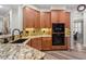 Modern kitchen featuring granite countertops, stainless steel appliances, and wood cabinetry at 4014 Peeler Ct, Rolesville, NC 27571