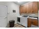 Functional laundry room with washer, dryer, cabinets, sink, and wood-look flooring at 4014 Peeler Ct, Rolesville, NC 27571