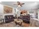 Cozy living room featuring plush leather sofas and an open-concept design leading to the kitchen and dining area at 4014 Peeler Ct, Rolesville, NC 27571