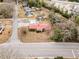 Aerial view of the property highlighting its brick exterior, spacious lot, and proximity to amenities at 410 E Mcneill St, Lillington, NC 27546