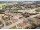 Aerial view showing multiple residential properties in a neighborhood with tree-lined streets at 410 E Mcneill St, Lillington, NC 27546