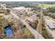 Aerial view showcases property with pond in neighborhood surrounded by lush greenery at 410 E Mcneill St, Lillington, NC 27546