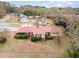 Aerial view of the home showcasing its red roof, landscaping, surrounding neighborhood, and detached shed at 410 E Mcneill St, Lillington, NC 27546