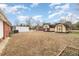 Fenced backyard featuring several sheds and storage buildings, with ample space at 410 E Mcneill St, Lillington, NC 27546