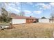 Large, flat backyard with partial fencing and a red roofed home at 410 E Mcneill St, Lillington, NC 27546