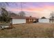 Home's rear exterior view reveals fenced-in backyard and access to the covered parking at 410 E Mcneill St, Lillington, NC 27546