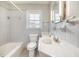 Bathroom featuring modern fixtures, a bathtub-shower combination, and updated tiling at 410 E Mcneill St, Lillington, NC 27546