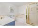 Bright bathroom featuring a bathtub, shower, and sink with updated finishes at 410 E Mcneill St, Lillington, NC 27546