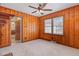 Bedroom featuring wood paneling, carpeted floors, and natural light at 410 E Mcneill St, Lillington, NC 27546