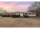 Charming single-story home featuring brick accents, white siding, and a well-manicured front yard at 410 E Mcneill St, Lillington, NC 27546