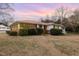 Charming home featuring a sunroom, well-maintained landscaping, and inviting facade at 410 E Mcneill St, Lillington, NC 27546