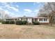 Inviting exterior view of the home featuring a red roof, landscaped yard, and classic architectural details at 410 E Mcneill St, Lillington, NC 27546