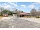 Single story home featuring a carport, screen porch and spacious paved driveway at 410 E Mcneill St, Lillington, NC 27546