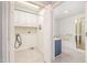Tiled laundry area including washer and dryer hookups, with an adjacent full bathroom at 410 E Mcneill St, Lillington, NC 27546