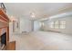 Large living room with a fireplace and a view to the entry door, perfect for entertaining guests at 410 E Mcneill St, Lillington, NC 27546