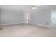 Spacious living room featuring a view into other rooms, carpeting, and ample natural light at 410 E Mcneill St, Lillington, NC 27546