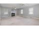 Spacious living room featuring a fireplace, carpeting, and ample natural light at 410 E Mcneill St, Lillington, NC 27546