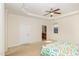 Bedroom with a ceiling fan, neutral walls and view into the bathroom at 430 Easy Wind Ln, Garner, NC 27529