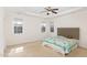 Bright bedroom with a ceiling fan, multiple windows, and neutral carpet at 430 Easy Wind Ln, Garner, NC 27529
