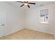 This bedroom features neutral carpet, a ceiling fan, and a window for natural light at 430 Easy Wind Ln, Garner, NC 27529