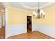 Traditional dining room with yellow walls, chandelier, and decorative molding at 430 Easy Wind Ln, Garner, NC 27529