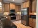 Spacious kitchen with stainless steel appliances, wooden cabinets, and black countertops at 430 Easy Wind Ln, Garner, NC 27529