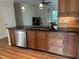 Kitchen with black countertops, stainless steel dishwasher, and a view to the outside at 430 Easy Wind Ln, Garner, NC 27529