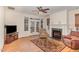 Comfortable living room with hardwood floors, fireplace, ceiling fan, and access to a screened porch at 430 Easy Wind Ln, Garner, NC 27529