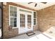 Brick patio featuring double french doors and sidelight windows at 430 Easy Wind Ln, Garner, NC 27529