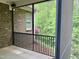 Charming screened porch with brick exterior, black railings, and tranquil forest views at 430 Easy Wind Ln, Garner, NC 27529