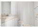 Compact bathroom featuring a white toilet, sink, vanity and neutral countertop at 432 Fowlkes St, Wendell, NC 27591