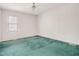 Bright bedroom features a ceiling fan, window and green carpet at 432 Fowlkes St, Wendell, NC 27591