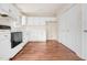 Well-lit kitchen equipped with white cabinets and modern appliances on a hardwood floor at 432 Fowlkes St, Wendell, NC 27591