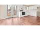 Bright kitchen with white cabinetry, black appliances, and a door leading to the deck at 432 Fowlkes St, Wendell, NC 27591