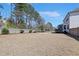 Large backyard with a patio, lush landscaping, and an open grassy area for versatile outdoor enjoyment at 4913 Sunset Stream Dr, Fuquay Varina, NC 27526