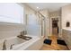 Bathroom features a large soaking tub, glass-enclosed shower, and access to walk-in closet at 4913 Sunset Stream Dr, Fuquay Varina, NC 27526