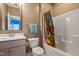 Neutral-toned bathroom featuring a bathtub with a themed shower curtain at 4913 Sunset Stream Dr, Fuquay Varina, NC 27526