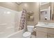 A full bath with a shower and tub combination plus decorative shelving near the toilet at 4913 Sunset Stream Dr, Fuquay Varina, NC 27526