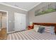 Bedroom with wood floors, natural light, neutral walls, white trim and closet with double doors at 4913 Sunset Stream Dr, Fuquay Varina, NC 27526