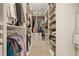 Walk-in closet featuring an abundance of shelving and storage for clothing and shoes at 4913 Sunset Stream Dr, Fuquay Varina, NC 27526
