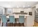 Open concept kitchen features an island with seating, quartz countertops, and stainless-steel appliances at 4913 Sunset Stream Dr, Fuquay Varina, NC 27526