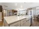 Modern kitchen with a center island and a stone fireplace and entertainment center in the background at 4913 Sunset Stream Dr, Fuquay Varina, NC 27526