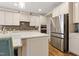 Modern kitchen features stainless steel appliances and beautiful quartz countertops, adding a touch of elegance at 4913 Sunset Stream Dr, Fuquay Varina, NC 27526